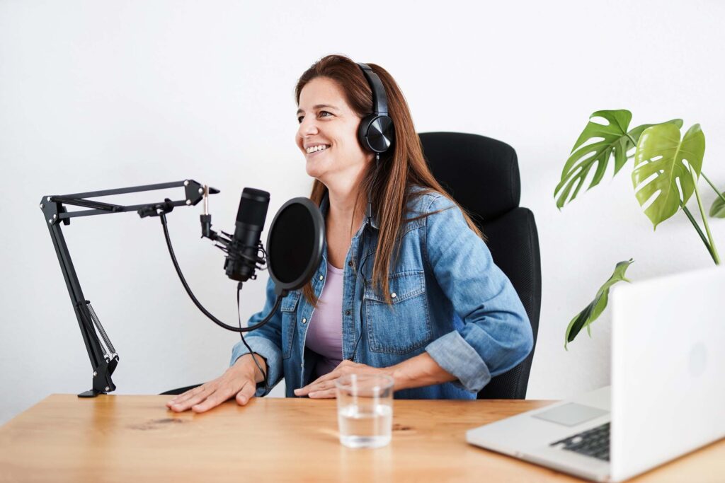 mature-woman-recording-a-podcast-inside-studio-CWLGPAG.jpg